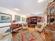 Comfortable living room featuring hardwood floors, arm chairs, and a built in entertainment center at 75 N Canal Dr, Palm Harbor, FL 34684