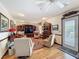 Comfortable living room featuring hardwood floors, arm chairs, and a built-in entertainment center at 75 N Canal Dr, Palm Harbor, FL 34684
