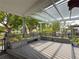 Gray wooden deck with built in bench seating and flower boxes overlooking backyard at 75 N Canal Dr, Palm Harbor, FL 34684
