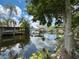 Picturesque waterfront view featuring serene canal waters, boat docks, and lush greenery at 75 N Canal Dr, Palm Harbor, FL 34684