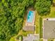 A high angle view of the pool and cabana at the community center, surrounded by mature trees at 7616 Wimpole Dr, New Port Richey, FL 34655