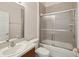 Bathroom with shower and tub combination, vanity, toilet, and tile at 7616 Wimpole Dr, New Port Richey, FL 34655