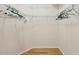 Walk-in closet featuring wire shelving and hardwood floors at 7616 Wimpole Dr, New Port Richey, FL 34655