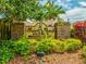 Community sign for Briar Patch Village surrounded by lush greenery and beautiful landscaping at 7616 Wimpole Dr, New Port Richey, FL 34655