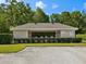 Community clubhouse with a covered veranda, fenced pool area, and well-maintained landscaping at 7616 Wimpole Dr, New Port Richey, FL 34655