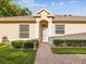 Charming single-story home with a brick walkway and well-maintained landscaping at 7616 Wimpole Dr, New Port Richey, FL 34655