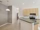 Bright kitchen offers tile floors, wooden cabinets, stainless steel appliances, and peninsula counter at 7616 Wimpole Dr, New Port Richey, FL 34655