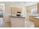 Eat-in kitchen featuring tile floors, wooden cabinetry, green countertops, and white tile backsplash at 7616 Wimpole Dr, New Port Richey, FL 34655