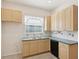 Kitchen with light cabinets, stainless steel sink, and a window at 7616 Wimpole Dr, New Port Richey, FL 34655