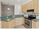 Kitchen featuring countertops, stainless steel oven, and light cabinets at 7616 Wimpole Dr, New Port Richey, FL 34655
