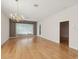 Spacious living room with hardwood floors and large windows at 7616 Wimpole Dr, New Port Richey, FL 34655