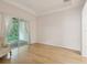 Living room featuring hardwood floors, trey ceiling, and sliding glass door at 7616 Wimpole Dr, New Port Richey, FL 34655