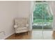 Living room featuring hardwood floors, a chair, and sliding glass door at 7616 Wimpole Dr, New Port Richey, FL 34655