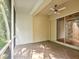 Outdoor porch area with brick flooring, a ceiling fan, and a screened-in enclosure at 7616 Wimpole Dr, New Port Richey, FL 34655