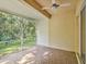 Outdoor porch area with brick flooring, a ceiling fan, and a screened-in enclosure at 7616 Wimpole Dr, New Port Richey, FL 34655