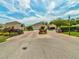 Inviting entrance to a neighborhood with manicured landscaping and beautiful homes beneath a sunny, partly cloudy sky at 7616 Wimpole Dr, New Port Richey, FL 34655