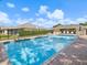 Beautiful pool with lounge seating and nearby clubhouse, perfect for relaxation and community enjoyment at 7616 Wimpole Dr, New Port Richey, FL 34655