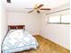 Comfortable bedroom featuring a ceiling fan, natural light and carpet flooring at 7715 Gulf Highlands Dr, Port Richey, FL 34668