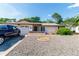 Charming single-story home with landscaped front yard, a brick facade and an attached garage at 7715 Gulf Highlands Dr, Port Richey, FL 34668