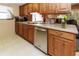 Cozy kitchen featuring wood cabinetry, modern appliances, and a bright window at 7715 Gulf Highlands Dr, Port Richey, FL 34668