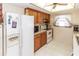 Efficient kitchen layout featuring oak cabinets and bright, natural lighting at 7715 Gulf Highlands Dr, Port Richey, FL 34668