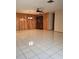 Open living area with tile flooring, wood accent wall, and stylish ceiling fan at 7715 Gulf Highlands Dr, Port Richey, FL 34668
