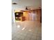 Spacious living room with tile flooring and wood paneling, flowing into the dining area at 7715 Gulf Highlands Dr, Port Richey, FL 34668