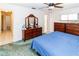 Cozy main bedroom with a ceiling fan, carpet flooring and matching dresser and nightstand set at 7715 Gulf Highlands Dr, Port Richey, FL 34668