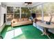 Enclosed sunroom featuring multiple windows offering views of the backyard at 7715 Gulf Highlands Dr, Port Richey, FL 34668