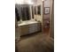 Bathroom with a white vanity, an oval sink and a large mirror in a well-lit space at 8008 La Serena Dr, Tampa, FL 33614