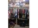 Walk-in closet featuring ample storage with hanging clothes and a TV for convenience at 8008 La Serena Dr, Tampa, FL 33614