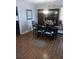 Dining room with wood-look flooring and a black table set for six, illuminated by a chandelier at 8008 La Serena Dr, Tampa, FL 33614