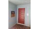 Charming front door with a brick entryway and decorative wall art at 8008 La Serena Dr, Tampa, FL 33614
