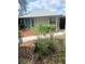 Landscaped front yard with vibrant greenery and a well-maintained walkway at 8008 La Serena Dr, Tampa, FL 33614