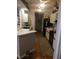 Traditional-style kitchen with white cabinets, black appliances, and wood-look flooring at 8008 La Serena Dr, Tampa, FL 33614