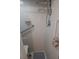 Handicap accessible shower stall with tiled walls, safety bars, seat and adjustable shower head at 8008 La Serena Dr, Tampa, FL 33614