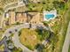 Aerial view of a community clubhouse, pool, and parking showcasing the layout at 8137 Morning View Dr, Hudson, FL 34667