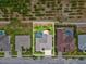 Aerial view of a property with a screened-in pool, patio, mature trees, and attractive landscaping at 8137 Morning View Dr, Hudson, FL 34667