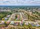 Aerial view of community with landscaped yards, swimming pools, tree-lined streets, and well-maintained homes at 8137 Morning View Dr, Hudson, FL 34667