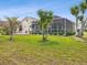 Beautiful backyard with a screened-in pool and patio area, framed by lush landscaping for privacy at 8137 Morning View Dr, Hudson, FL 34667