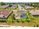 Backyard showcasing outdoor living space with screened-in pool and patio area surrounded by lush landscaping and lawn at 8137 Morning View Dr, Hudson, FL 34667