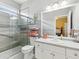 Bright bathroom featuring a glass enclosed shower, gray countertops and stylish decor at 8137 Morning View Dr, Hudson, FL 34667