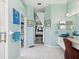 Well-lit primary bathroom with a double vanity and view into the main bedroom at 8137 Morning View Dr, Hudson, FL 34667