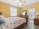 Bedroom with wooden furniture, soft bedding, and a view into the adjacent bathroom at 8137 Morning View Dr, Hudson, FL 34667