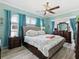 Comfortable bedroom with soft blue walls, large windows, and stylish furnishings at 8137 Morning View Dr, Hudson, FL 34667