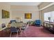 Carpeted card room with a round poker table surrounded by seating and landscape paintings at 8137 Morning View Dr, Hudson, FL 34667