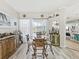 Dining area featuring a glass table and unique chairs leading to an outdoor pool area at 8137 Morning View Dr, Hudson, FL 34667