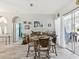Dining area with glass table, unique chairs, and sliding glass doors to outdoor at 8137 Morning View Dr, Hudson, FL 34667