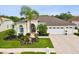 Charming single-story home with a well-manicured lawn, a paver driveway, and a three-car garage at 8137 Morning View Dr, Hudson, FL 34667