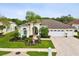 Charming single-story home with a well-manicured lawn, a paver driveway, and a three-car garage at 8137 Morning View Dr, Hudson, FL 34667